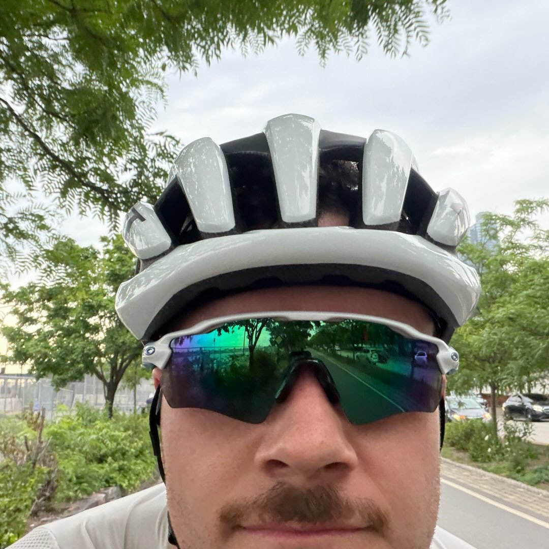Cam, founder of bike.build, in helmet and sunglasses on a ride